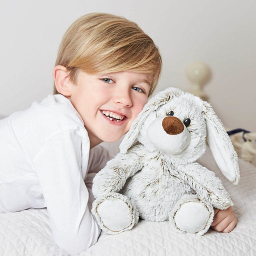 Little boy cuddling up to the grey bunny rabbit whilst smiling for a picture